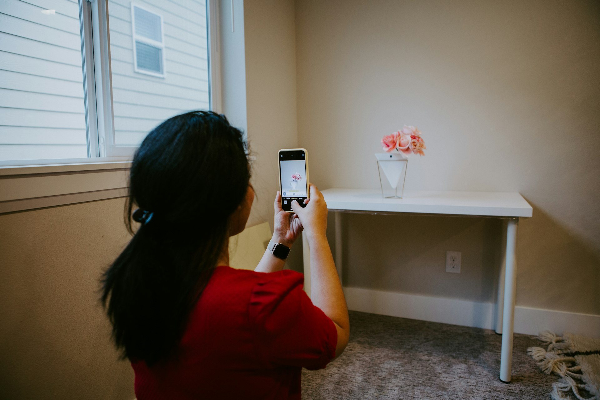 woman in red long sleeve shirt holding silver iphone 6